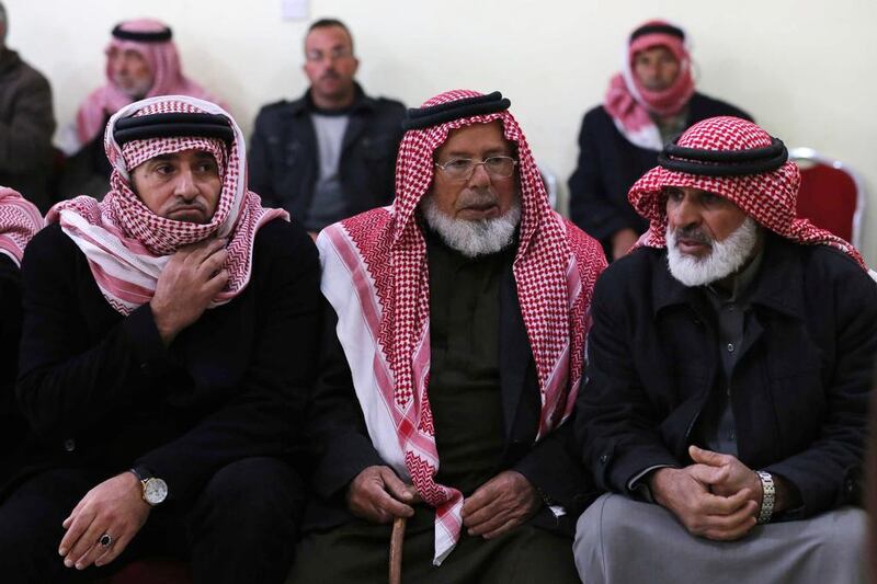 Friends and relatives of Maaz Al Kassasbeh, a Jordanian pilot captured by ISIL, gather in southern Jordan. Photo: Raad Adayleh / AP