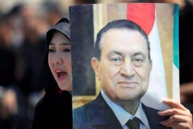 A supporter of Hosni Mubarak demonstrates outside a courtroom in Cairo yesterday. Khalil Hamra / AP Photo