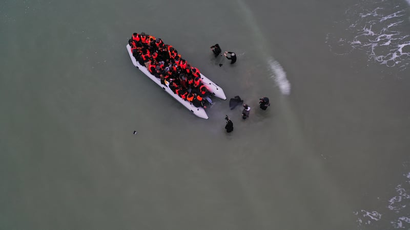 A group of migrants prepare to launch an overcrowded inflatable dinghy from the French coast, near Calais, heading for England. Reuters