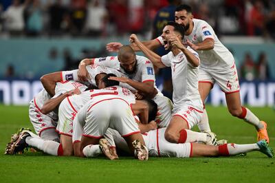 Tunisia's team celebrate after scoring what would be the winning goal in their group stage match against France at the Qatar World Cup on November 30, 2022.  AFP