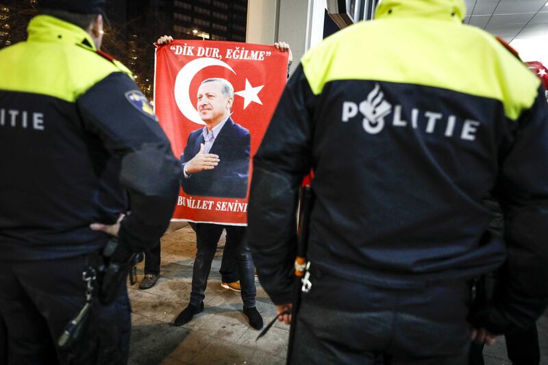 A protester holds a placard with a picture of Turkish president Recep Tayyip Erdogan outside the Turkish consulate in Rotterdam, the Netherlands. Bas Czerwinski / EPA