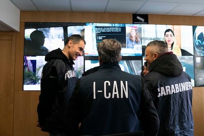 Police officers talk at Interpol's headquarters in Lyon, France, on Thursday. AP