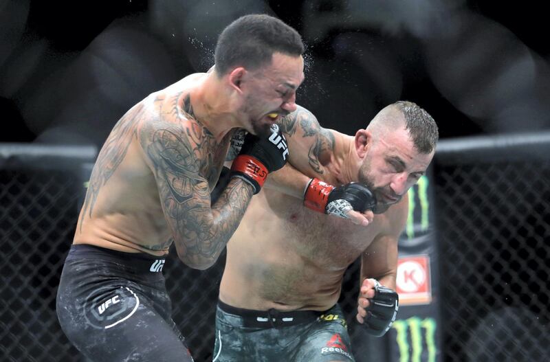 LAS VEGAS, NEVADA - DECEMBER 14: Alexander Volkanovski (R) punches UFC featherweight champion Max Holloway in their title fight during UFC 245 at T-Mobile Arena on December 14, 2019 in Las Vegas, Nevada. Volkanovski took the title by unanimous decision.   Steve Marcus/Getty Images/AFP