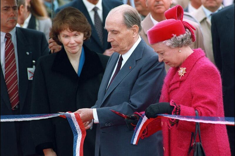 French president François Mitterrand, centre, and Queen Elizabeth II cut a ribbon at the inauguration of the Channel Tunnel in Calais, France on May 6, 1994. Gerard Fouet / AFP