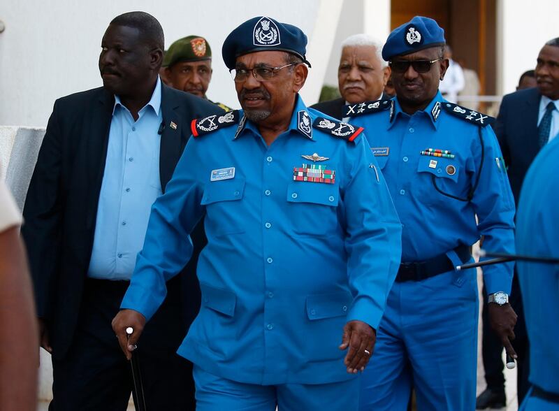 Sudanese President Omar al-Bashir arrives to meet with police officials at the headquarters of the "police house" in the capital Khartoum on December 30, 2018. Sudan's top Islamist party, a member of Bashir's government, called on December 26 for a probe into the killings of protesters in demonstrations that have rocked the economically troubled country. Angry crowds have taken to the streets in Khartoum and several other cities since December 19 when the government tripled the price of bread.
 / AFP / ASHRAF SHAZLY
