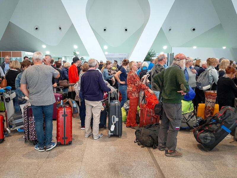 Passengers wait for their flights at the Marrakesh Airport on March 15, 2020. - Several special flights departed Morocco taking thousands of stranded Europeans home as the kingdom announced it was suspending all regular air traffic due to the coronavirus, authorities and airports said. Morocco said it had decided to suspend all international commercial flights "until further notice", extending a ban that had previously been applied to around 30 nations, including Italy, France and Spain. (Photo by - / AFP)