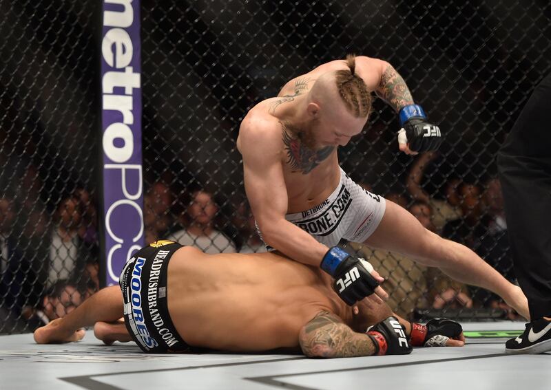 LAS VEGAS, NV - SEPTEMBER 27:  (Top) Conor McGregor punches Dustin Poirier in their featherweight fight during the UFC 178 event inside the MGM Grand Garden Arena on September 27, 2014 in Las Vegas, Nevada.  (Photo by Jeff Bottari/Zuffa LLC/Zuffa LLC via Getty Images)