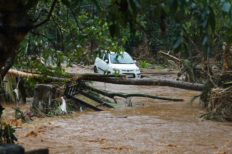 A car is stuck in floodwater in Thodupuzha, Kerala, after heavy rains caused flash floods in the southern Indian state on Saturday, October 16. AFP