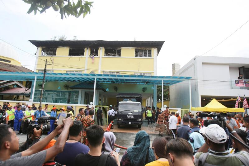 Malaysian police truck waits outside an Islamic religious school following a fire on the outskirts of Kuala Lumpur. Daniel Chan / AP Photo