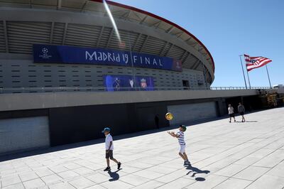 Soccer Football - Champions League Final - Preview - Wanda Metropolitano, Madrid, Spain - May 29, 2019 Children play with a ball outside the stadium. REUTERS/Susana Vera