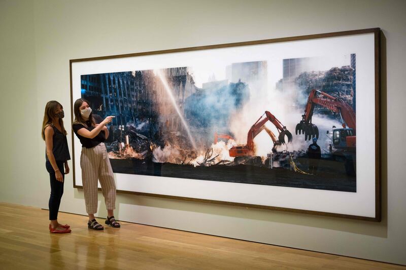 Museum staff pose during a photocall for ‘Wim Wenders: Photographing Ground Zero’ exhibition at the Imperial War Museums (IWM) in London on September 10, 2021.  (Photo by Tolga Akmen  /  AFP)  /  RESTRICTED TO EDITORIAL USE - MANDATORY MENTION OF THE ARTIST UPON PUBLICATION - TO ILLUSTRATE THE EVENT AS SPECIFIED IN THE CAPTION