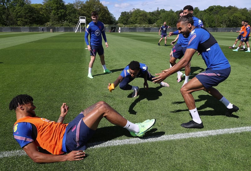 MIDDLESBROUGH, ENGLAND - JUNE 04: Jesse Lingard of England dives for team mate Tyrone Mings in a game of tag whilst Mason Mount and Dominic Calvert-Lewin laugh during the England training session on June 04, 2021 in Middlesbrough, England. (Photo by Eddie Keogh - The FA/The FA via Getty Images)