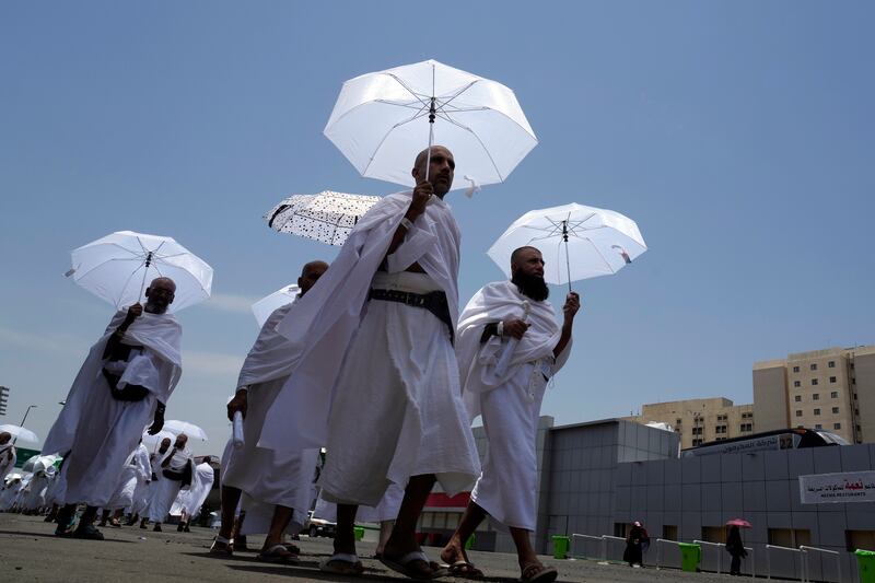 At the largest Hajj since the Covid pandemic began, Muslim pilgrims carry umbrellas to provide shade as temperatures reach very high levels in Mina, near Makkah. AP