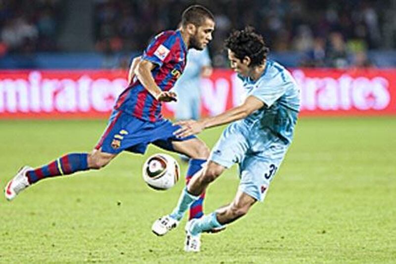 Dani Alves, left, takes on Atlante's Daniel Arreola during the Club World Cup in Abu Dhabi.