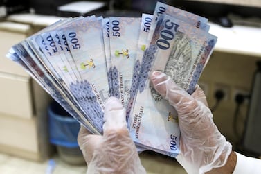 A Saudi money exchanger counts Saudi riyal currency in Riyadh, Saudi Arabia. Reuters
