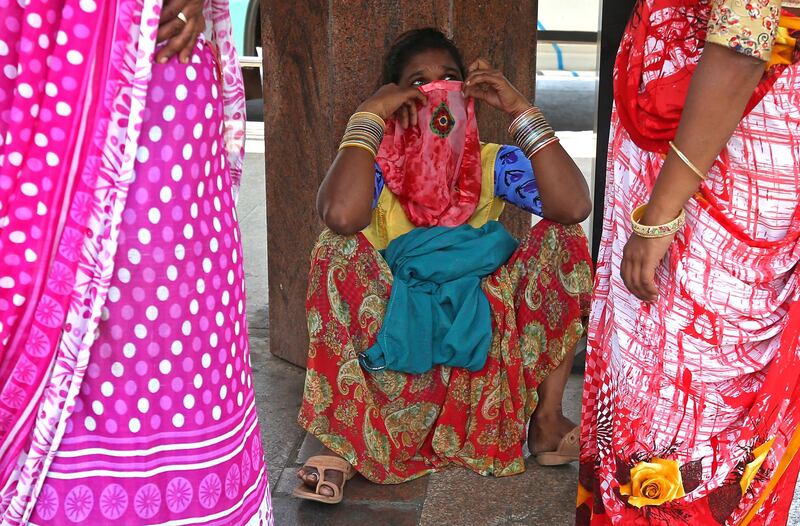A woman covers her mouth in Bangalore, India, on April 7, 2021. The country recorded 115,736 new coronavirus cases in the latest 24-hour reporting period, the highest daily figure since the start of the pandemic. A second wave of Covid-19 in India has led several states, including Maharashtra and the capital, New Delhi, to reimpose restrictions. EPA
