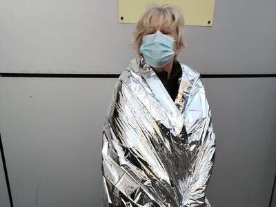 Suzanne Styles wrapped in foil after being evacuated from her quarantine hotel during a fire alert. Photo: Suzanne Styles 