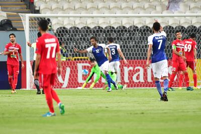 Al Hilal's defender Yasser Al-Shahrani (C) celebrates after scoring during the first leg of their AFC Champions League semi-final football match at the Mohammed Bin Zayed Stadium in Abu Dhabi on September 26, 2017.  / AFP PHOTO / GIUSEPPE CACACE