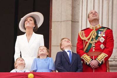 The young royals on the balcony of Buckingham Palace alongside their parents for an RAF flypast. AFP.