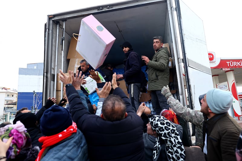 People gather to collect food and humanitarian aid in the Elbistan district of Kahramanmaras, south-east Turkey. EPA