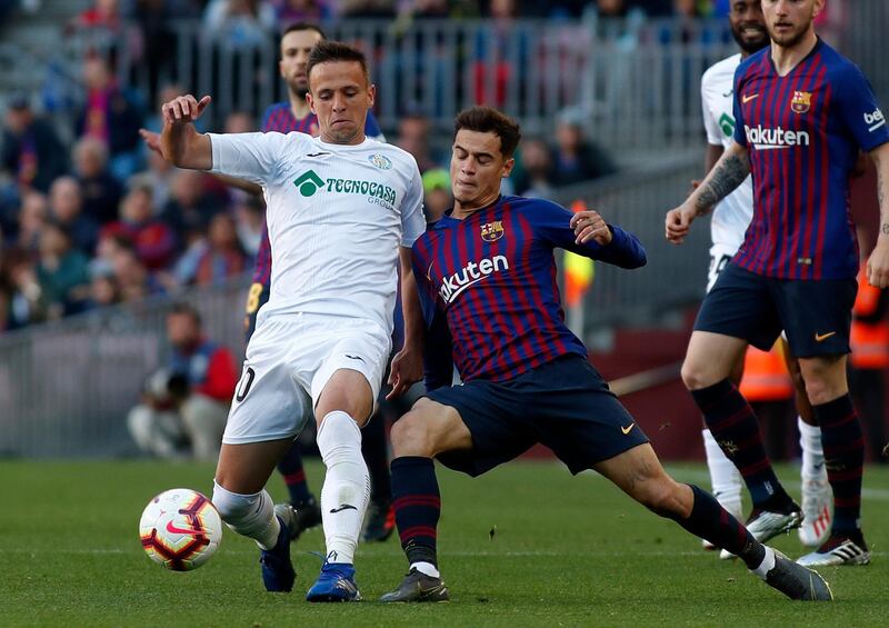 Philippe Coutinho fights for the ball with Nemanja Maksimovic. AP Photo