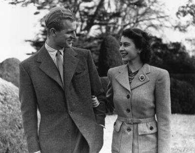 Photographed during their November 1947 honeymoon, Princess Elizabeth and the Duke of Edinburgh stand in the gardens of Broadlands Country House. The future queen is wearing the chrysanthemum sapphire brooch. Getty