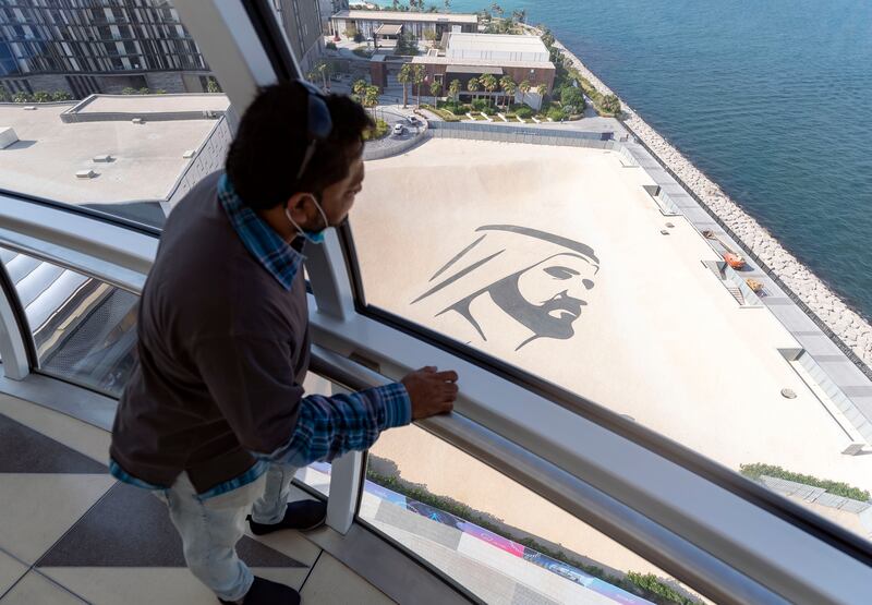 An illustration of Sheikh Mohammed bin Rashid, Vice President and Ruler of Dubai, on the ground beneath Ain Dubai