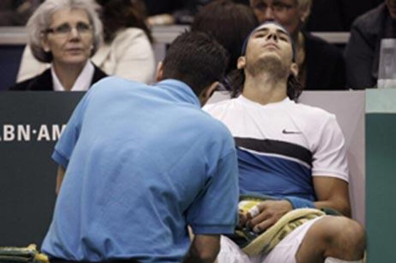 Rafael Nadal receives treatment on his right leg during the final of the ABN Amro event in Rotterdam. The injury could see him miss the Dubai Tennis Championships.