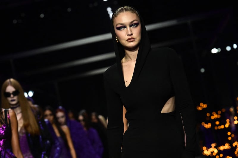 Gigi presents a creation for Versace's women's spring/summer 2023 as part of Milan Fashion Week. AFP