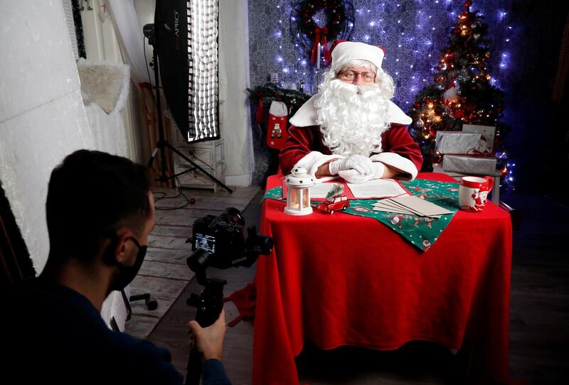 Janos Nemes, dressed as Santa Claus, interacts with children by video in Budapest, Hungary. Reuters