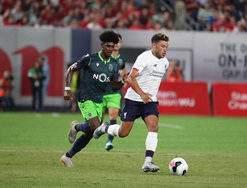 Liverpool's Alex Oxlade-Chamberlain, right, runs past Sporting's Therry Correia. AFP