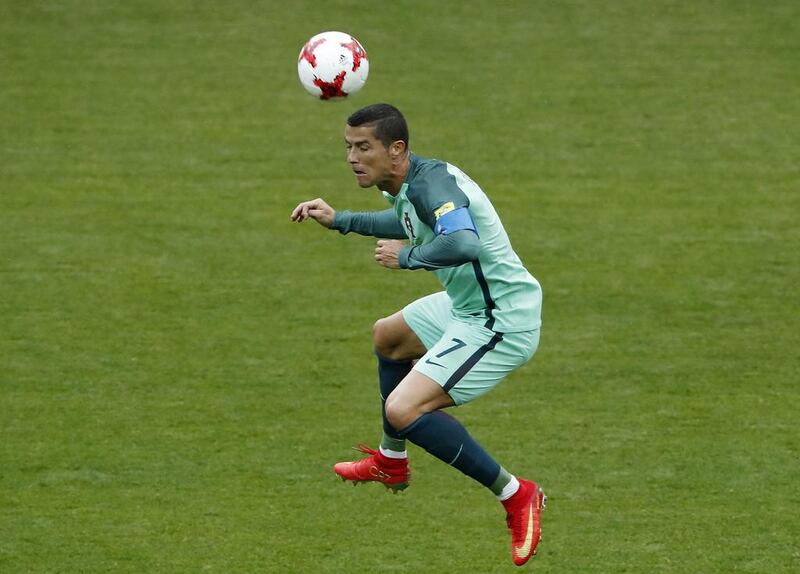 Portugal's Cristiano Ronaldo jumps for the ball during the Confederations Cup match against Russia. AP Photo