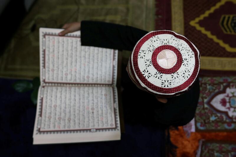 Son of the Jordanian Imam Ahmad al Harasis reads holy Koran at his home prior to Taraweeh prayer during the holy fasting month of Ramadan as prayers by worshippers in the holy places are suspended due to concerns about the spread of the coronavirus disease (COVID-19), in Amman, Jordan May 11, 2020. REUTERS/Muhammad Hamed