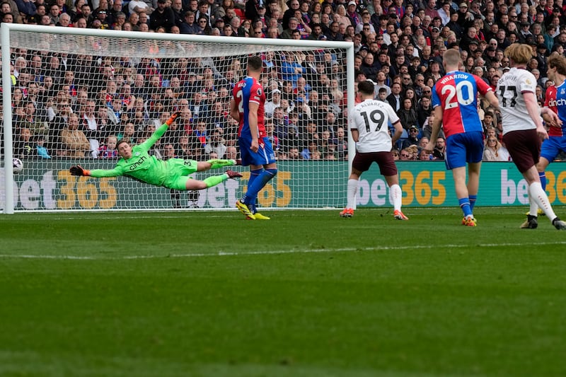 Manchester City's Kevin De Bruyne, right, scores his side's fourth goal past Crystal Palace goalkeeper Dean Henderson. AP