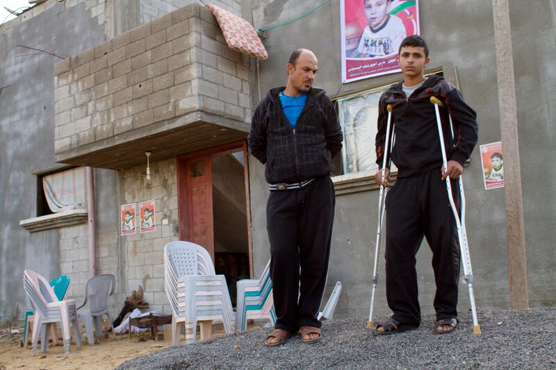 Nader Basioni walks with his crutches with his father Achmed outside their home in the northern Gazan town of Beit Hanoun. After an Israeli airstrike slammed into a nearby field on November 15, his nightmares replay in graphic detail how a fleck of metal from that explosion tore through the family home and decapitated his nine-year-old brother, Fares, who was sleeping in the same room.
ÒHis head was gone except for a piece skin of his face,Ó Nader, 14, recalled at his home in Beit Hanoun, in the northern Gaza Strip.
ÒIÕm afraid to sleep because I see him in my dreams. ItÕs the same thing over and over Ð Fares is gone. HeÕs dead.Ó (Photo by Heidi Levine/Sipa Press for The National)
