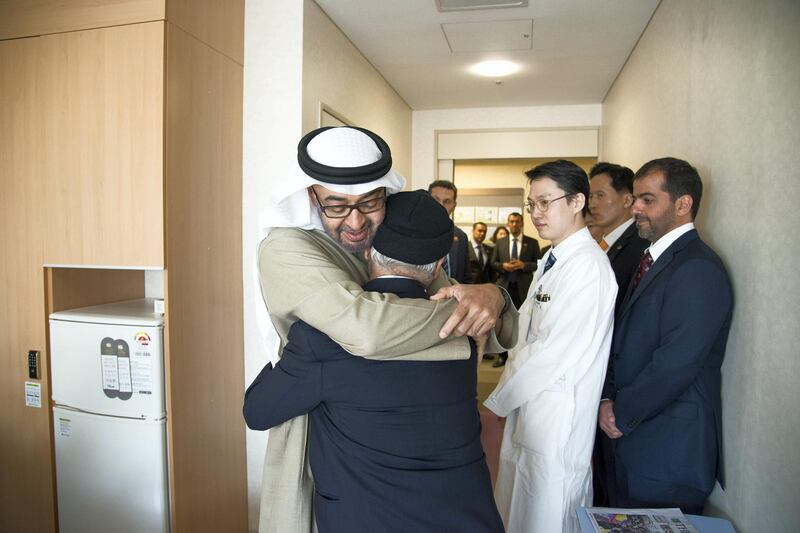 SEOUL, REPUBLIC OF KOREA (SOUTH KOREA) - February 27, 2014: HH General Sheikh Mohamed bin Zayed Al Nahyan Crown Prince of Abu Dhabi Deputy Supreme Commander of the UAE Armed Forces (C) embraces the father of an Emirati patient receiving treatment at Seoul Saint Mary's Hospital in the Republic of Korea. Seen with HH Sheikh Hamed bin Zayed Al Nahyan Chairman of Crown Prince Court - Abu Dhabi and Executive Council Member (back R). 
 ( Mohamed Al Suwaidi / Crown Prince Court - Abu Dhabi )