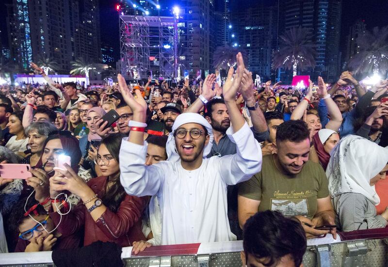 Dubai, United Arab Emirates-  Visitors watching the concert Free DSF concert at the Burj Park, Dubai Downtown, Ruel Pableo for The National