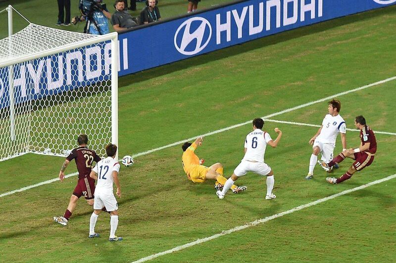 Russia forward Alexander Kerzhakov, far right, shoots and scores the equaliser in a 1-1 draw with South Korea during 2014 World Cup Group H play on Tuesday in Cuiaba, Brazil. Pedro Ugarte / AFP