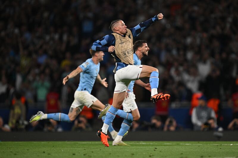 TOPSHOT - Manchester City's English midfielder #4 Kalvin Phillips celebrates at the final whistle after they won the UEFA Champions League final football match between Inter Milan and Manchester City at the Ataturk Olympic Stadium in Istanbul, on June 10, 2023.  (Photo by Paul ELLIS  /  AFP)