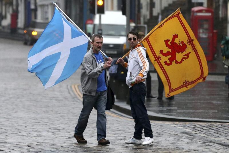 Supporters of the Yes campaign for the Scottish independence referendum stand on the Royal Mile in Edinburgh. Scott Heppell / AP Photo