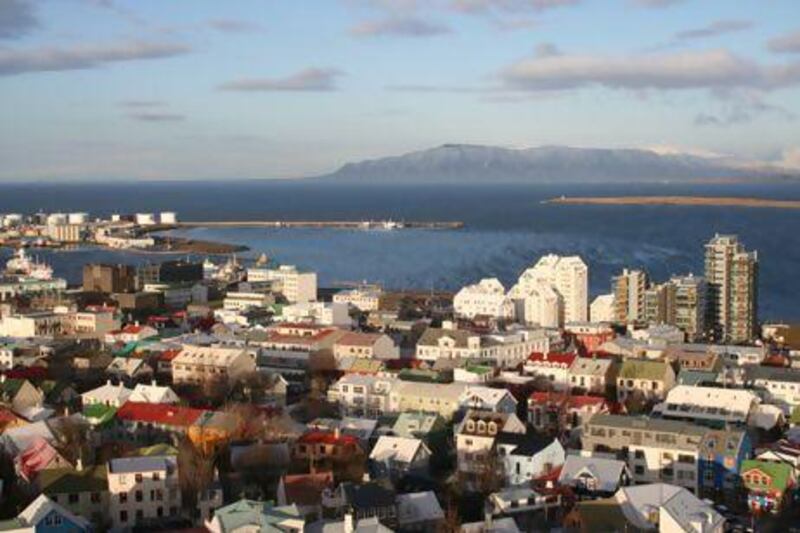 Glaciers, volcanoes, hot springs and snorkelling are within reach from Reykjavik. Seen here, the city centre and the harbour. Lonely Planet / Getty Images