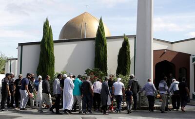 FILE - In this March 23, 2019 file photo, worshippers prepare to enter the Al Noor mosque following the previous week's mass shooting in Christchurch, New Zealand. A comprehensive report released Tuesday, Dec. 8, 2020 into the 2019 Christchurch mosque shootings in which 51 Muslim worshippers were slaughtered sheds new light on how the gunman was able to elude detection by authorities as he planned out his attack. (AP Photo/Mark Baker, File)