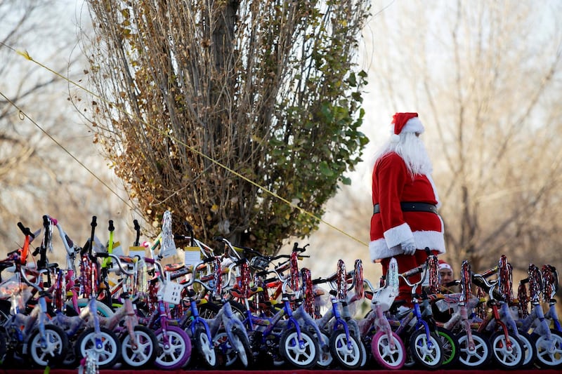 A firefighter dressed as Santa Claus stands by bicycles during the annual gift-giving event organised by the Fire Department, in which they hand out items donated throughout the year to children in need, in Ciudad Juarez, Mexico. Reuters