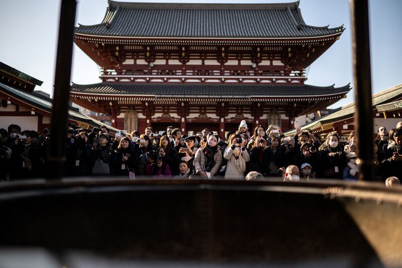 Parents watch as kindergarten students take part in a bean-throwing ceremony to drive away evil spirits and bring good luck at the annual Setsubun Festival at Sensoji Temple in Tokyo. AFP