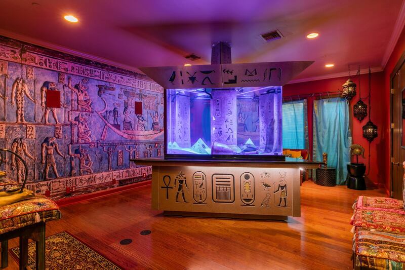 An Egyptian-themed room, complete with hieroglyphics on the walls, has majlis-style seating and comes with an enormous pyramid-shaped saltwater aquarium. The home starred in the MTV show Cribs in 2003.