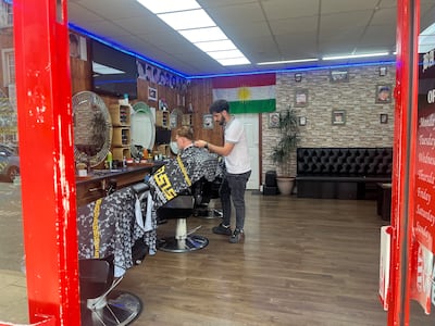 A Kurdish flag on the wall inside Rewa Ahmad's barber shop. The National