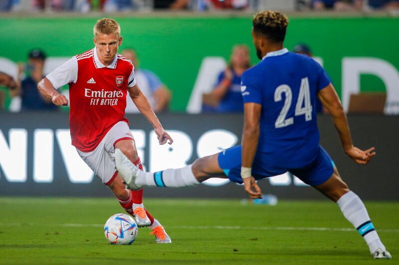 Arsenal midfielder Oleksandr Zinchenko runs with the ball as Chelsea defender Reece James attempts a tackle. USA Today