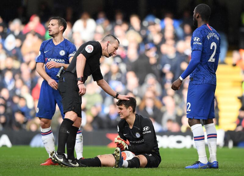 Referee Kevin Friend pats Chelsea goalkeeper Kepa Arrizabalaga on the head. Getty