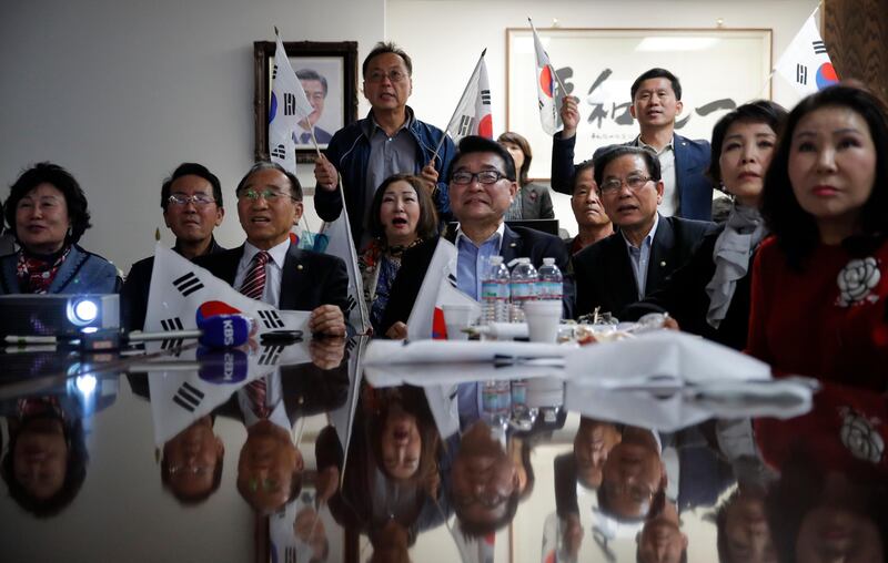 Members of South Korea's National Unification Advisory Council, Los Angeles Chapter, watch a live broadcast. AP Photo / Jae C. Hong