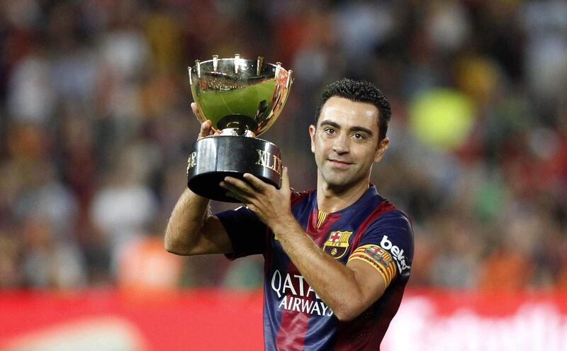 epa08565651 (FILE) - FC Barcelona captain Xavi Hernandez holds the trophy after defeating Club Leon in the Joan Gamper Trophy soccer match played at Camp Nou stadium in Barcelona, northeastern Spain, 18 August 2014 (reissued 25 July 2020). FC Barcelona's legend and Qatar's Al-Sadd SC current head coach announced on his official instagram account on 25 July 2020 that he had tested positive for COVID-19.  EPA/Toni Albir *** Local Caption *** 51526646